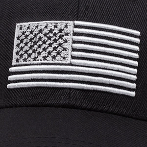 Close-up of black cotton baseball cap featuring detailed American flag embroidery on front