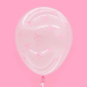 Detail of transparent latex balloon with pink bow prints and stars for party decor