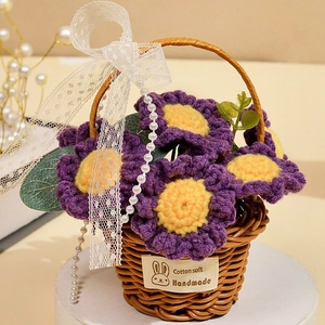 Detailed view of hand-knitted purple sunflower in basket with lace bow and pearl chain