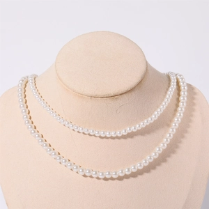Elegant double-layer glass pearl necklace with high luster on a beige display mannequin