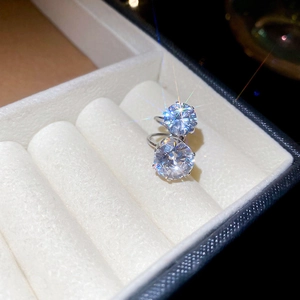 Macro shot of minimalist silver ear cuffs with sparkling round-cut cubic zirconia stones