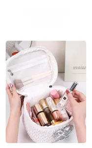 Interior view of a white woven makeup bag with heart detail and cosmetic storage