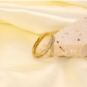 Detailed macro view of a gold-plated titanium ring with full eternity diamond inlay