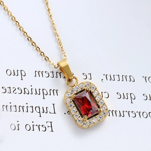 Macro shot of 18K gold plated necklace featuring a rectangle red zircon pendant with halo crystals