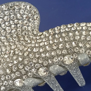 Detailed macro view of sparkling silver acrylic hair claw clip with full diamond inlay