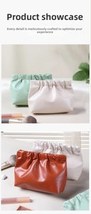 Detail of leather cosmetic pouches in sage green, beige, and caramel with spring closure