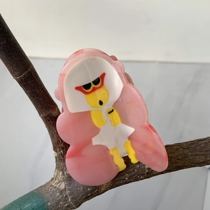 Cellulose acetate hair claw clip featuring a cute cartoon duck on a light pink base