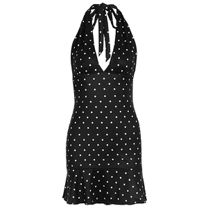 Detail of deep V-neck halter design and white polka dot pattern on black summer dress