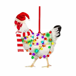 Close-up of a white Christmas chicken ornament with a red scarf and Santa hat on white background