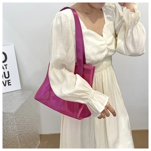 Detailed close-up of a large magenta translucent tote bag with purple nylon straps