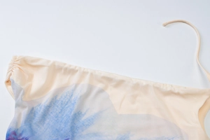 Detail view of floral print top showing refined stitching and adjustable strap texture