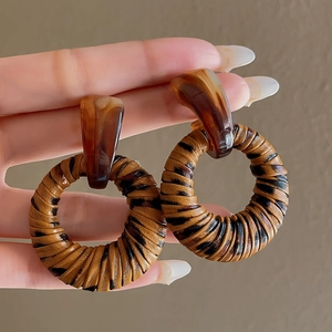 Detail of vintage leopard print hoop earrings with amber resin geometric top studs