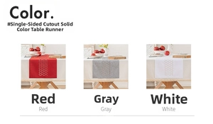 Detail of red, gray, and white hollow geometric table runners with cut-out triangle patterns