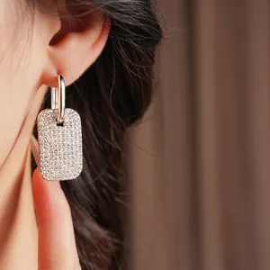 Sparkling silver rectangular drop earrings with micro-pave crystals on model