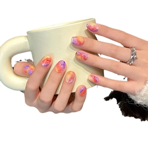 Handmade marble swirl press-on nails with purple and orange watercolor effects