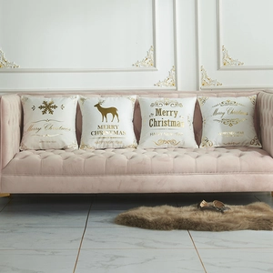 Set of four white and gold Christmas pillow covers with reindeer and snowflake prints