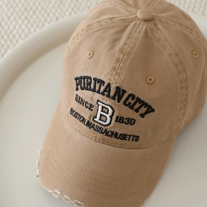 Detail of khaki distressed baseball cap with vintage Boston B embroidery and worn edges
