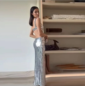 Detailed back view of sexy silver sequin evening dress with cross back straps