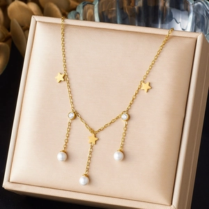 Gold star necklace with pearls and rhinestones on elegant silk jewelry box display