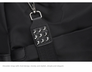 Detail of black nylon strap with silver metal studs and clip on shoulder bag