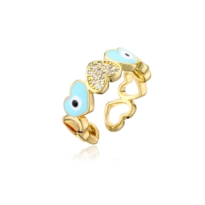 Macro detail of gold open ring with evil eye heart and sparkling zircon setting