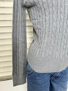 Detail showing the gray cable knit texture and slim fit design of the retro V-neck sweater