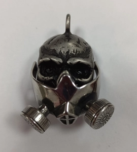 Macro view of retro stainless steel skull gas mask pendant with vintage silver finish