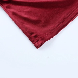 Detailed close-up of dark red satin dress showing premium stitching and fabric texture