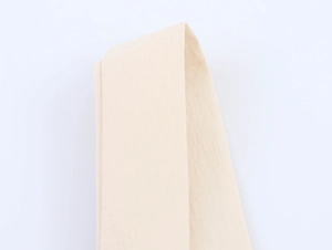 Macro close-up showing the fine woven texture of the beige lace camisole strap