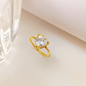 Macro shot of heart-shaped zircon ring with gold plated titanium steel prong setting