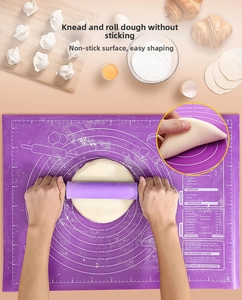 Detail of purple silicone baking mat with measurements and matching rolling pin in use