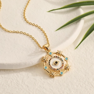Macro detail of gold Evil Eye pendant with colorful zircon stones and enamel accents