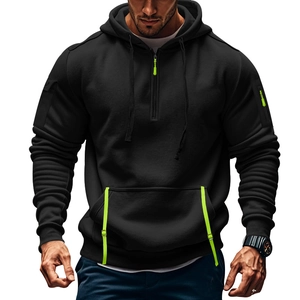 Men's black hoodie with neon green accents featuring a half-zip and arm pocket