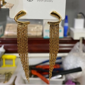 Elegant gold long tassel earrings with geometric curved hooks and tiered metal fringe