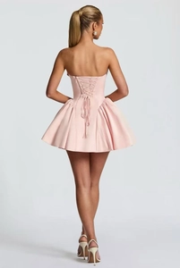 Close-up of pink strapless mini dress featuring a back lace-up design and puffy skirt