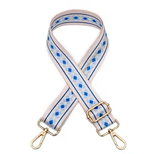 Detailed view of adjustable wide purse strap with blue diamond geometric pattern