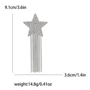 Close-up of shooting star brooch with rhinestones and long metal fringe tassels