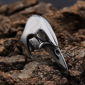 Gothic punk style stainless steel bird skull open ring on a rustic wood background