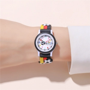 Detail of soccer themed kids watch with embossed football pattern on black rubber strap