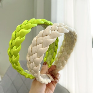 Braided fabric headbands in bright yellow and beige with a satin texture and woven design