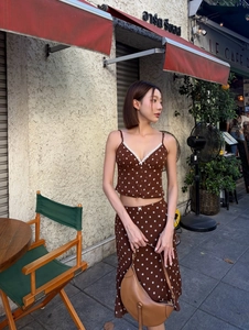 Detail of brown polka dot two-piece summer set featuring lace trim and ruffled edges