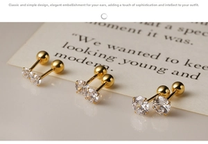 Macro shot of three pairs of S925 silver gold-plated stud earrings with screw-back design