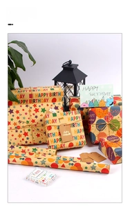 Detail of kraft birthday wrapping paper set with ribbons, tags and festive patterns