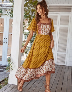 Detail of floral print patchwork dress featuring square neck and A-line silhouette