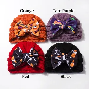 Baby Halloween turban hats with large bows featuring pumpkin and ghost prints in four colors