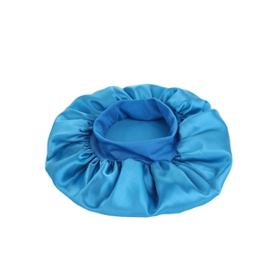 Close-up of royal blue satin sleep cap showing the glossy silk texture and elastic band