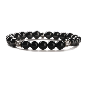 Beaded bracelet with black stones, silver spacers and crystal beads on white background