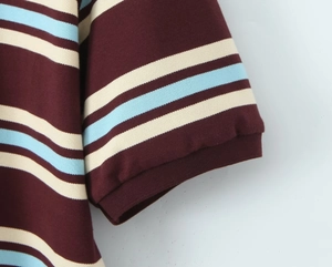 Close-up of striped short sleeve cuff with ribbed edge and precise stitching detail