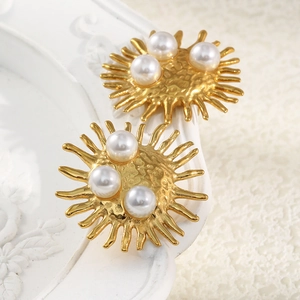 Detailed macro of 18K gold plated sunburst earrings with three elegant pearls