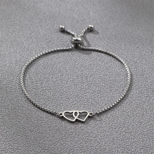 Detail of interlocking twin hearts silver bracelet with adjustable box chain bolo clasp